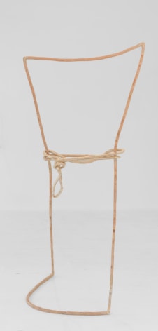 A standing sculpture that resembles a tall rectangle with a rope tied around the center, made of plywood that resembles a single line