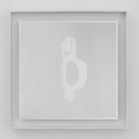 An artwork framed in white. On a grey ground, there is an abstract shape that is centrally situated in a square composition. The shape is white in this photograph.