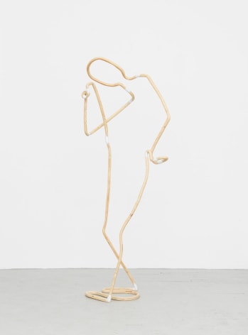 A photograph of a sculpture meant to look like a single line. The sculpture depicts a figure, standing, with a hand on their hip, and a hand to their head.