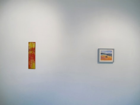 A photograph of 2 artworks hung on a white wall