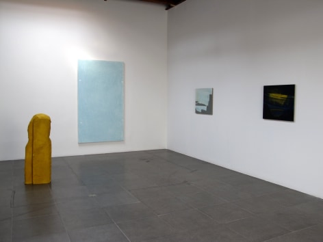 Installation of the art exhibition &quot;Heat Waves&quot; with 3 paintings on white walls and a yellow aqua resin sculpture