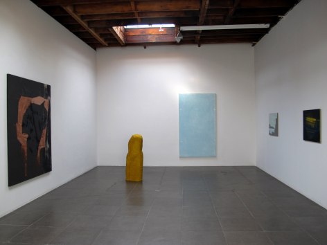 Installation of the art exhibition &quot;Heat Waves&quot; with 4 paintings on white walls and a yellow aqua resin sculpture