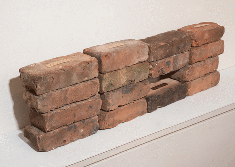 Fred Holland &quot;When...&quot;, 2015 Used brick, engraved brass plate, and thin cardboard 9-1/2 x 32-3/4 x 3-1/2 inches (installed dimensions) 2-1/2 x 8 x 3-1/2 inches (each brick)