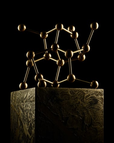 Fine Mineral photograph of a brass pyrite molecular model for wilensky exquisite minerals habits exhibition.