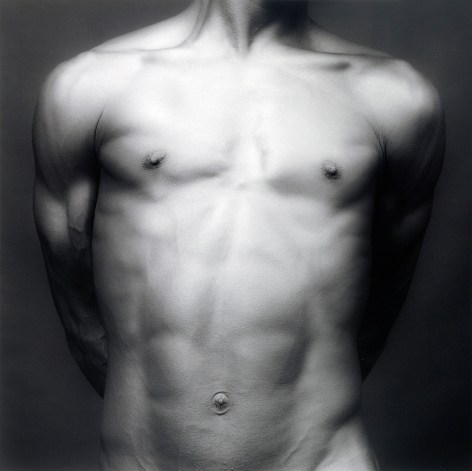 Nude black male's chest and torso.