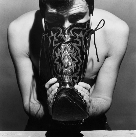 Manputting his face into boot.