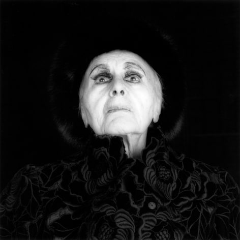 Louise Nevelson staring wide-eyed at the camera, wearing all black.