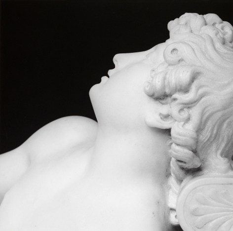 Statue of sleeping cupid in profile.