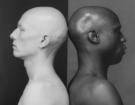 Two men in profile, facing apart with backs touching.