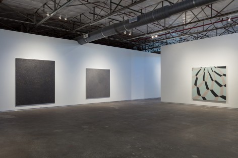 Installation view of Bleckner's show at Dallas Contemporary in 2017. The shot includes a large black square canvas, a square gray canvas, and a blue and gray dome painting.