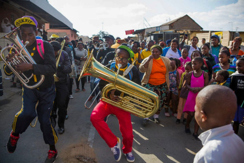 July 18th is Nelson Mandela Day Worldwide: Mr. Mandela turned 95 years old today. More than 100 senior citizens gathered at the Nelson Mandela Heritage Site to celebrate Mandela Day. Food and music was provided by a non-profit organization called Tshedbedisano Support Network in the Alexandra Township, South Africa. Towards the end of this celebration, a brass band arrived and provided free entertainment. It fit the theme of volunteerism in this nation and throughout the world in recognition to the sacrifices Mr. Mandela and others made to bring an end to apartheid,&nbsp;July 18, 2013.