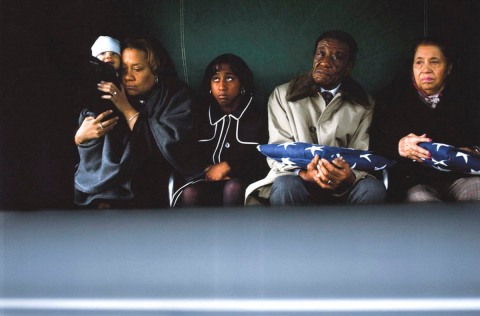 At the funeral of 1st Sgt. Charles M. King in Ohio: Former journalist, editor and now book publisher, Dana Candy, holds her child Jordan, at the funeral of his father, 1st Sergeant Charles M. King, who was killed October 14th, 2006 in Iraq. Also in the photograph is the daughter of King and his parents, 2006.