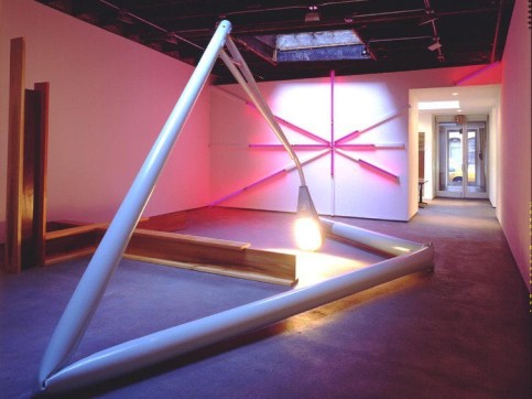 Art gallery installation of a sculpture show, with large, bent streetlight