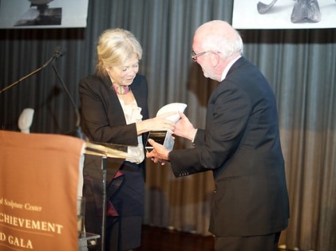 Color photographic of Alice Aycock receiving an award