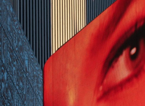 A red eye on a large LCD screen overlooking Times Square.