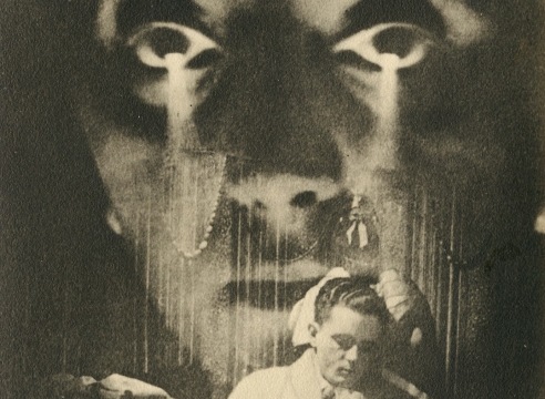 Black and white photo of a man reading with a large image of a woman's face superimposed over him.