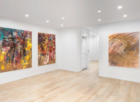 photo of a corner of a room with art on walls