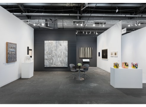 art fair installation view with paintings and sculpture