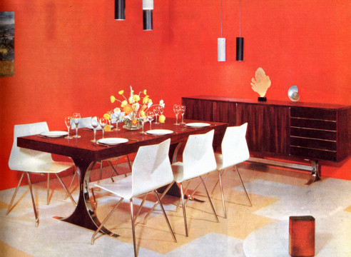 Dining room featuring René-Jean Caillette wood table, wood and metal legged chairs, metal pendant lights, and wooden server