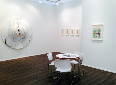 Art fair booth featuring works on paper and paintings