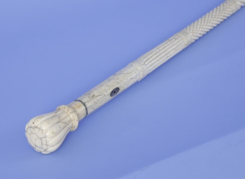 Whale ivory cane with a 12-sided petal grip with whale bone shaft with five carved sections, mid-19th century