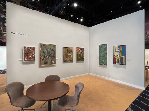 image of a white wall with various artworks on it