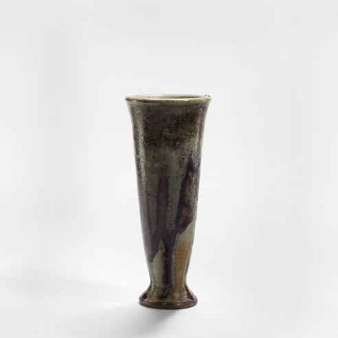 photograph of a ceramic vase in an empty room