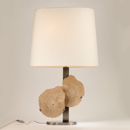 photograph of lamp in a white room with two overlapping circles in the middle of its base