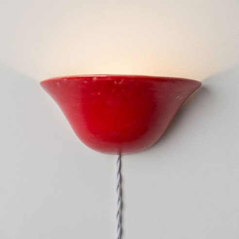 red sconce on a gray wall