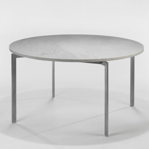 photograph of a table with steel legs and a marble top in a blank room