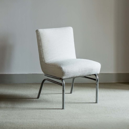 photograph of a white chair in an empty room