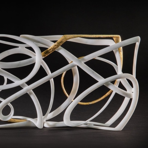 A white marble sculpture by Elizabeth Turk, with gold leaf
