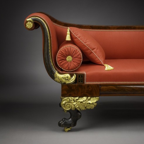 Récamier in the Neo-Classical Taste, about 1820. Attributed to Duncan Phyfe (1770–1854), New York. Mahogany, partially gilded and painted verde antique, with die-stamped gilt-brass mounts, bolster buttons, and castors, and die-stamped brass inlaid with ebony, 32 in. high, 82 3/4 in. long, 24 1/2 in. deep (detail).