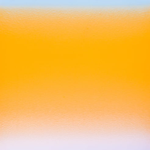 a colorfield painting by Stanley Twardowicz done with an airbrush showing a luminous band of blue blending into a large dominant field of orange into a band lilac at the bottom