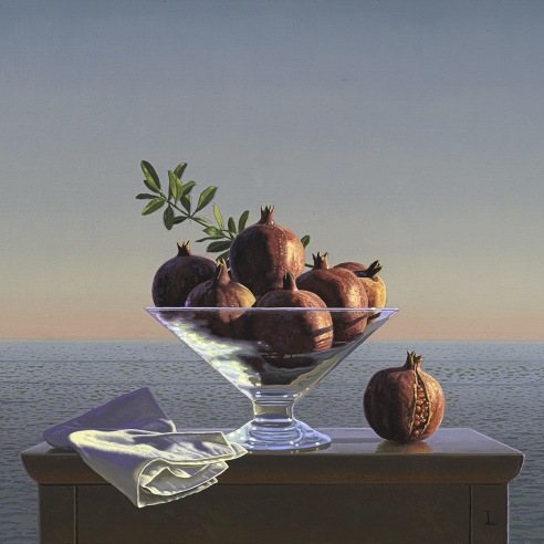 still life painting of pomegranates in a glass vase on a wooden table by the sea
