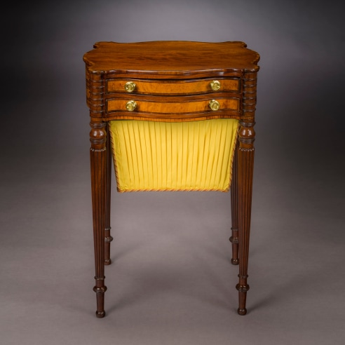 Work Table in the Sheraton Taste, about 1810. Attributed to Thomas Seymour, Boston. Mahogany, striped and bird’s eye maple, and ebony, with gilt-brass drawer knobs, and fabric work bag, 27 3/4 in. high, 19 1/4 in. wide, 15 3/4 in. deep