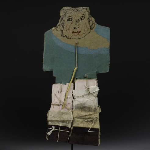 a paper construction/sculpture of a man wearing a blue coat by self-taught artist James Castle