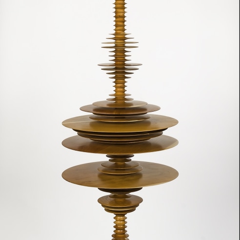 a sculpture by Elizabeth Turk of wood discs stacked and arranged to simultaneously resemble a Modernist abstraction and a sound wave
