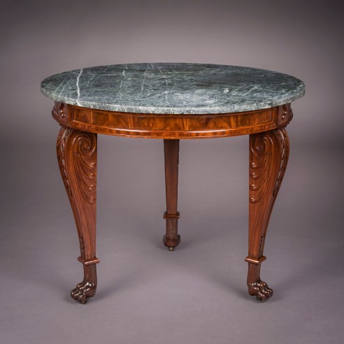 Center Table, about 1818–20 Attributed to Thomas Seymour (1771–1848), working either for James Barker or for Isaac Vose & Son, with Thomas Wightman (1759–1827) as carver, Boston. Mahogany, with brass castors and green marble top. 29 3/4 in. high, 36 in. diameter.