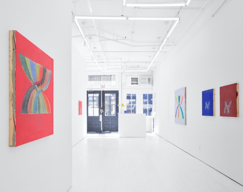 Gallery installation view, including several abstract works featuring rainbows 