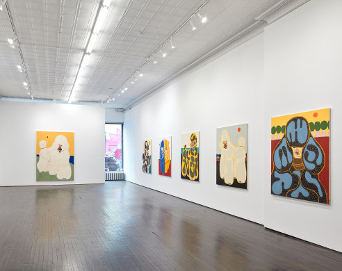Installation image of paintings featuring poodles