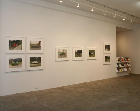 photos of automobiles on gallery wall