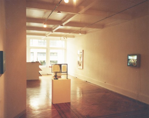 Installation view with light framed photographs