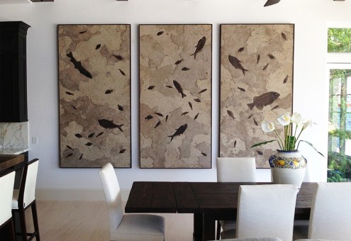 A large fossil stone triptych containing a variety of 50 million year old fossil fish decorate this dinning room.