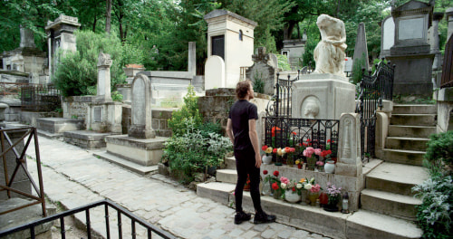 Man standing in front of grave