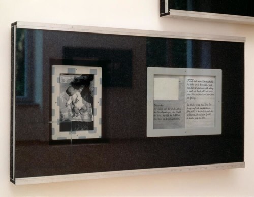 Framed artwork containing a baby photo and writing on notebook paper