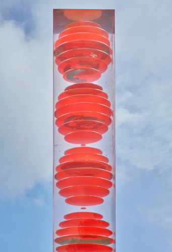 Sculpture close-up: rectangular column with red globes in plexi