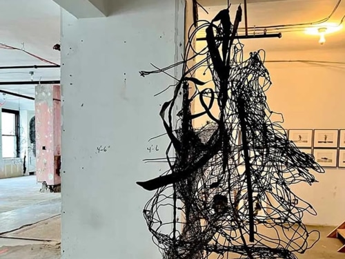 Hanging wire sculpture in a gallery