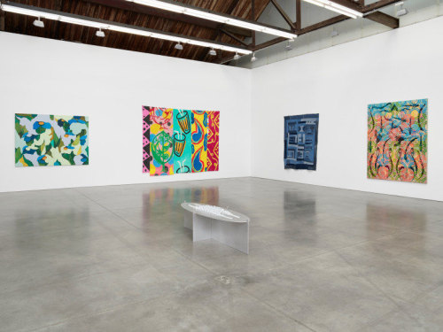 4 abstract paintings and 1 floor sculpture in an art gallery