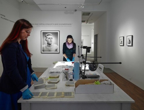 2 women processing artist archives on table